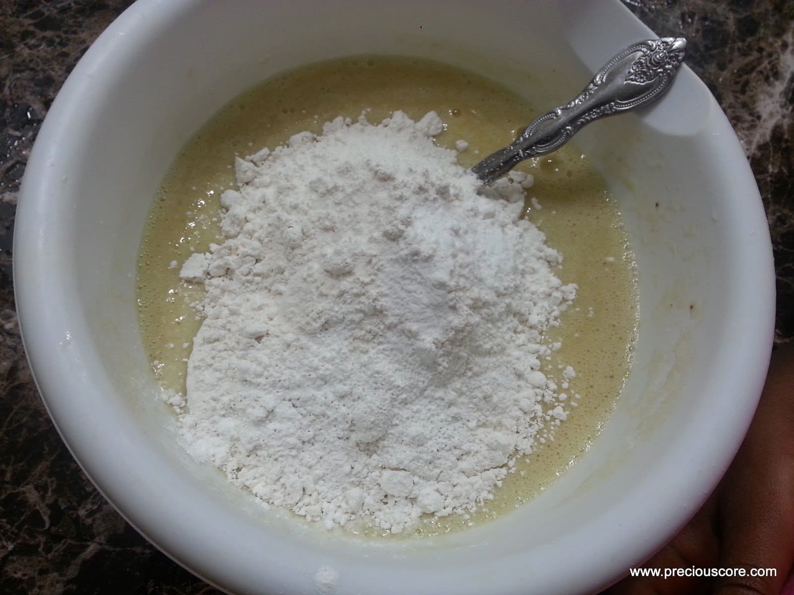 Pile of dry ingredients in a bowl of wet ingredients.