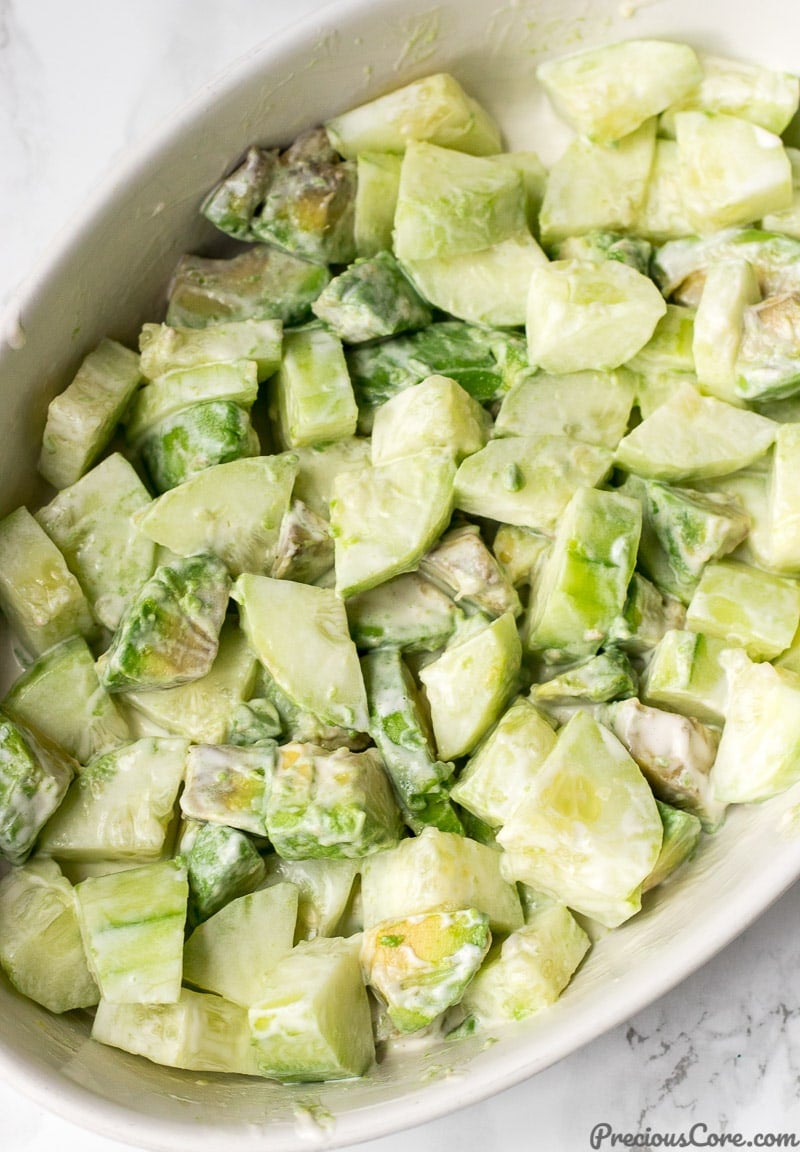 Cucumber Avocado Salad tossed with dressing