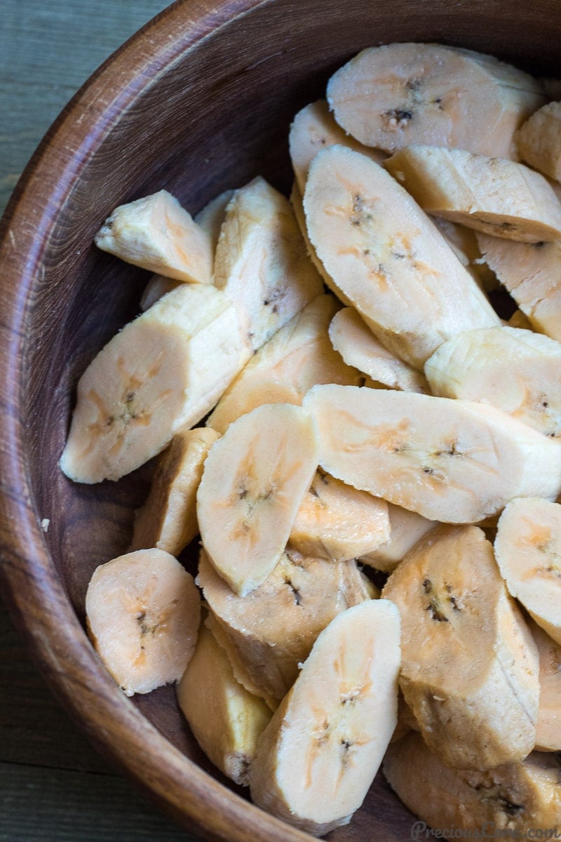 Slices of sweet plantains in a wooden bowl.