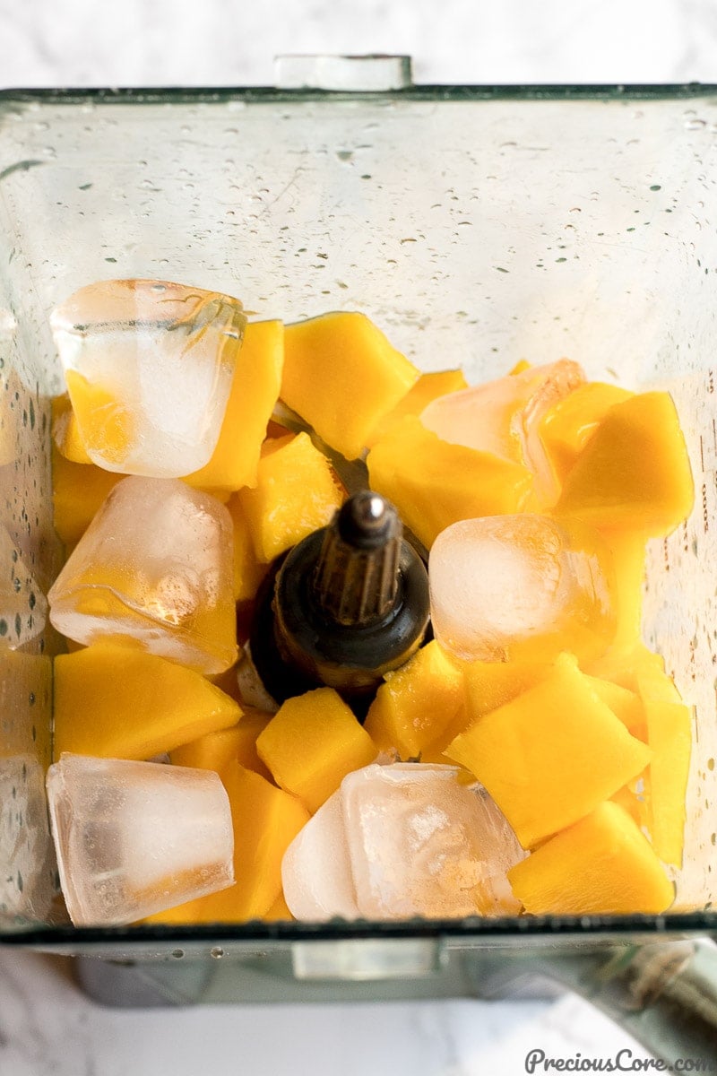 chopped mangoes in a blender for mango juice