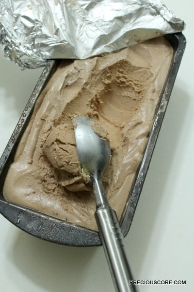 Spoon scooping chocolate ice cream.