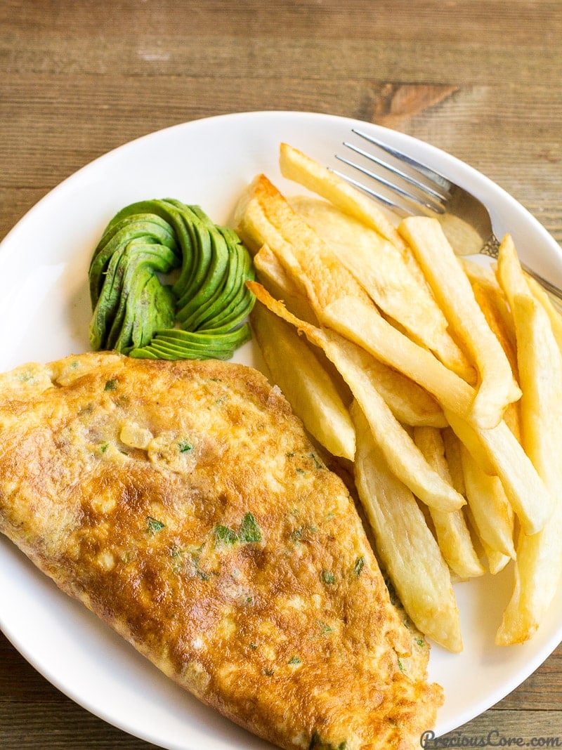 Fries and omelette for breakfast with some avocado.