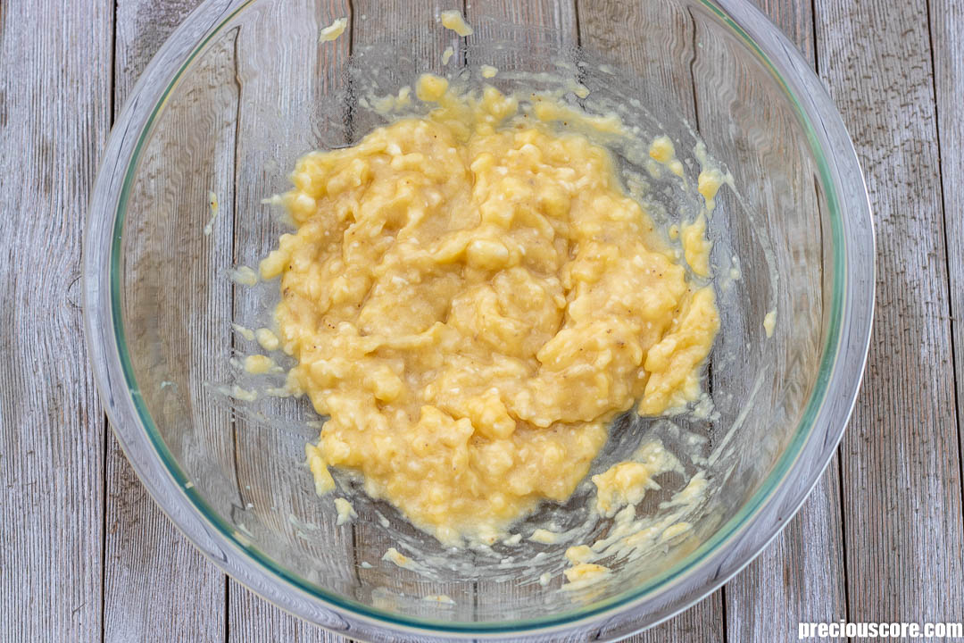 Mashed bananas in a mixing bowl.