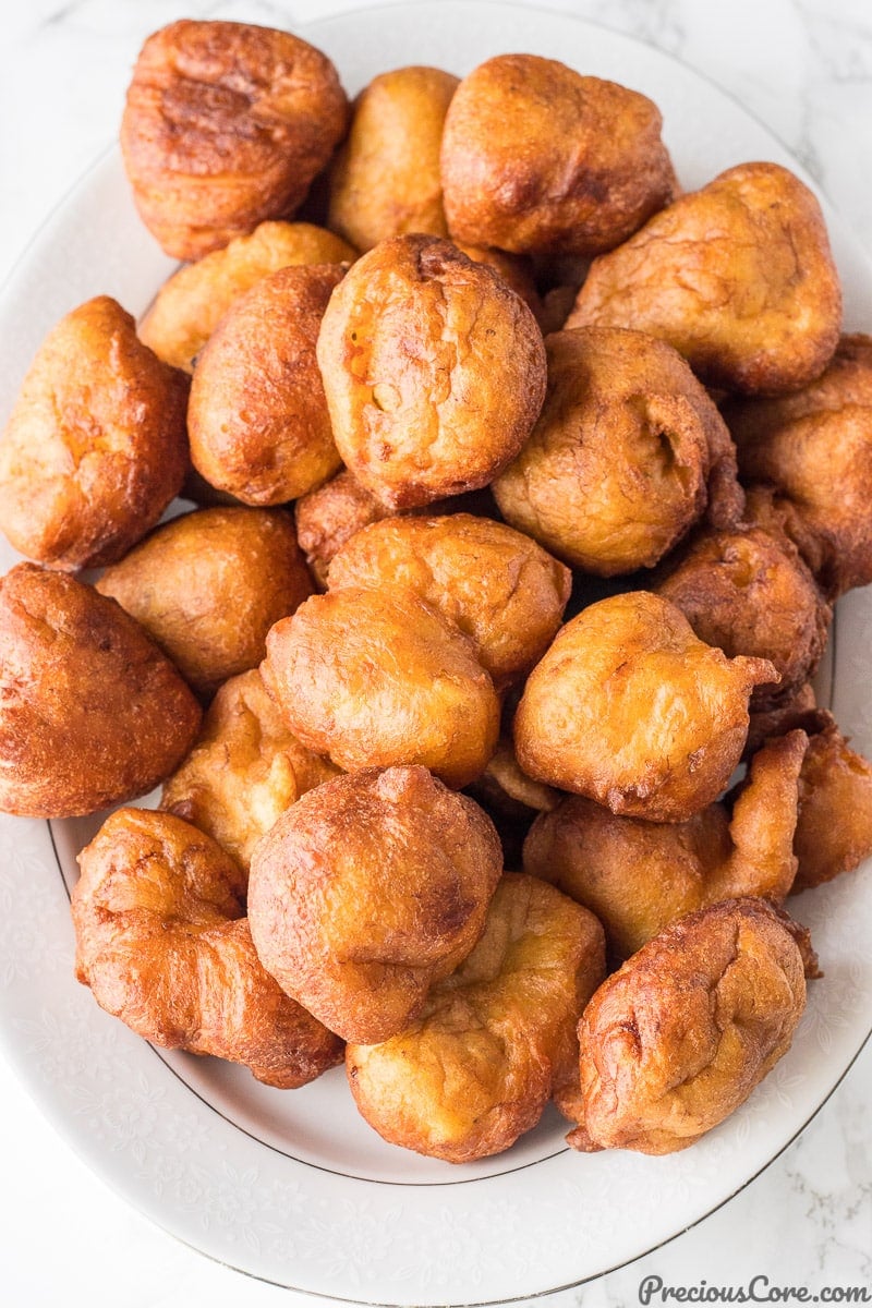 Brown fritters on a serving platter.