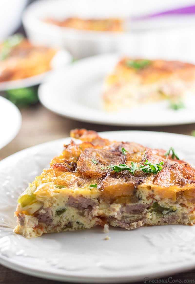 A triangular slice of Plantain Frittata on a white plate.