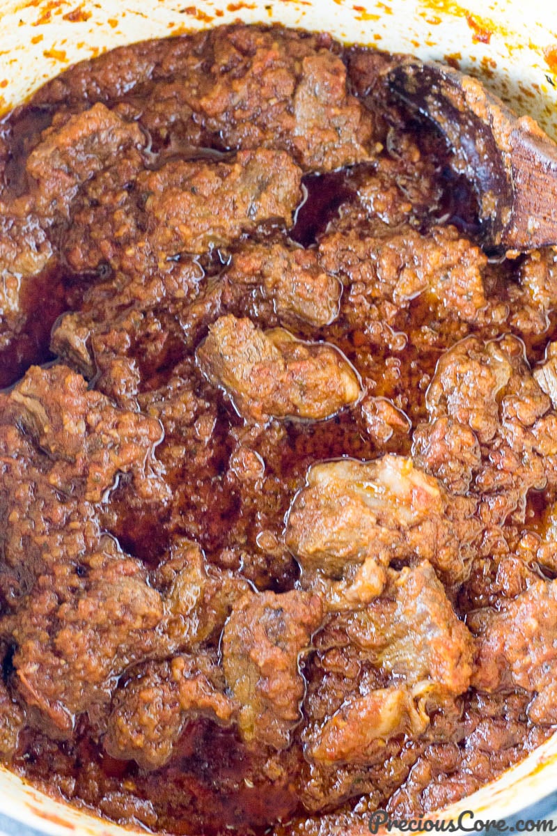 Wooden spoon in a pot of African Beef Stew.