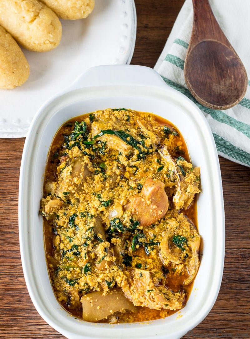 Egusi soup with meat in a white bowl.