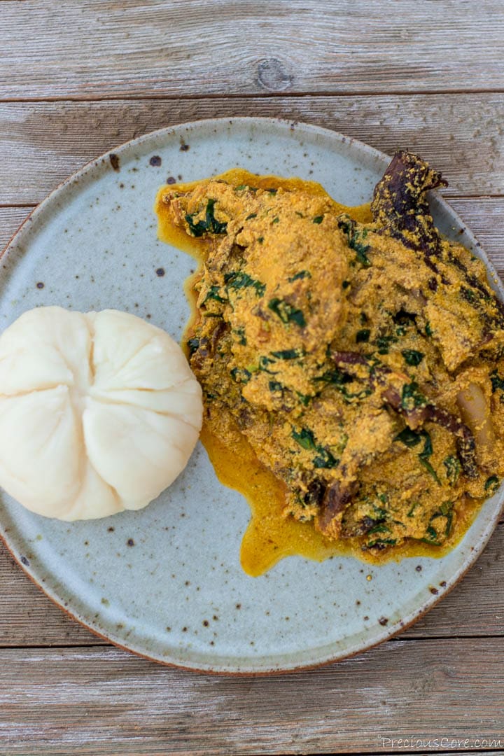 Egusi soup and pounded yam on a plate.