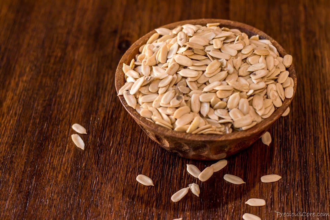 Egusi seeds in a wooden brown bowl.