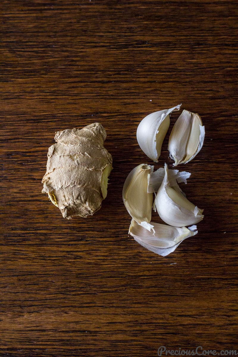 Ginger and garlic on a wooden surface.