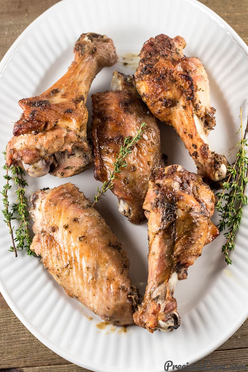 Freshly baked turkey wings on a white platter.