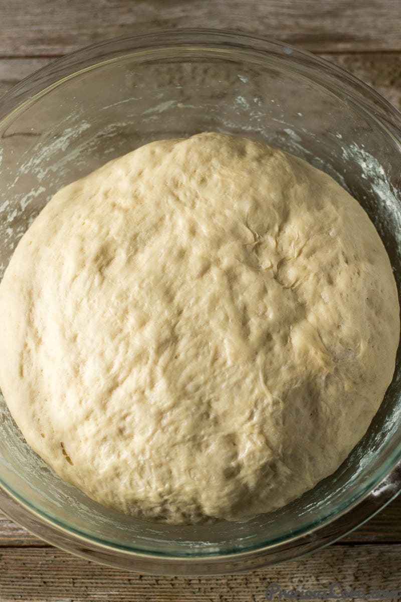 Glass bowl of beignet dough.