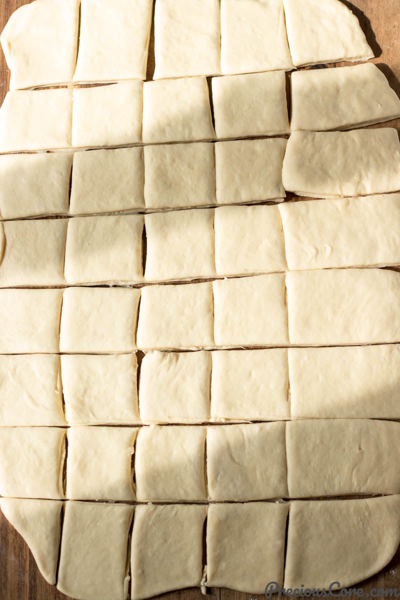 Beignet dough cut into squares.