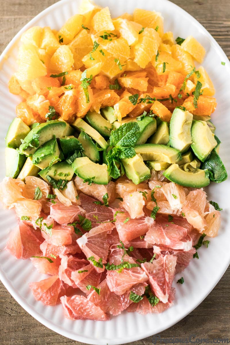 Citrus Salad with Avocado on a white plate.