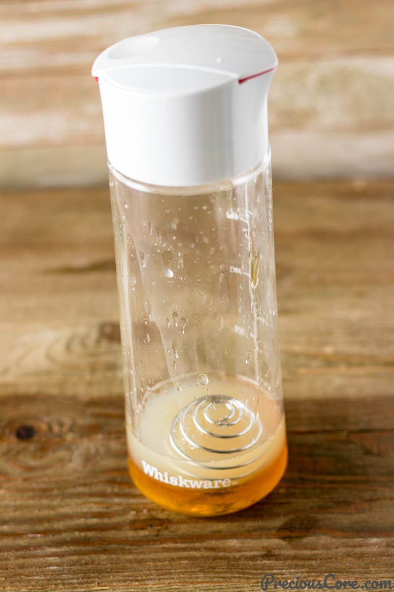 Whiskware dressing shaker filled with a citrus honey dressing.
