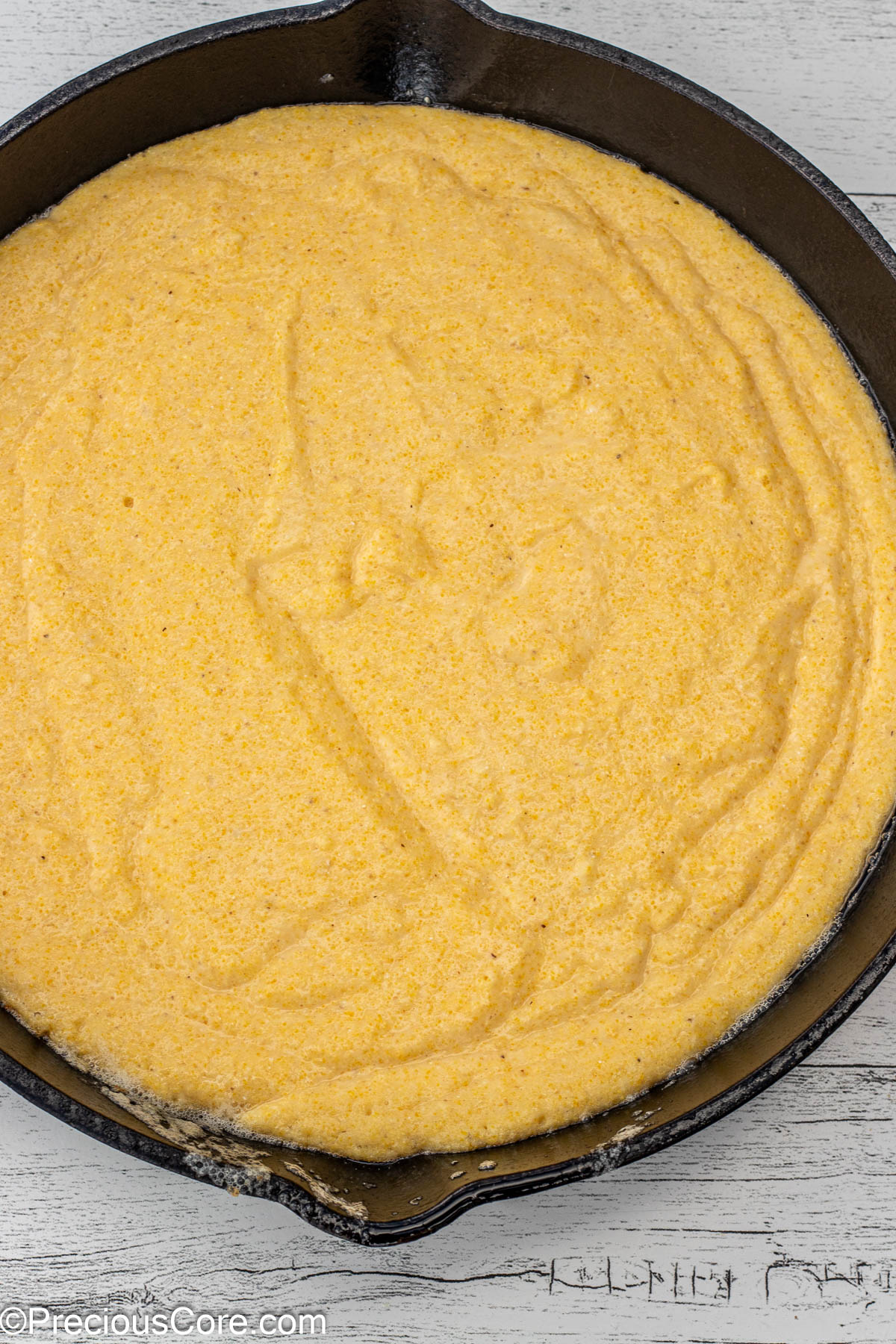 Cornbread batter in cast iron skillet.