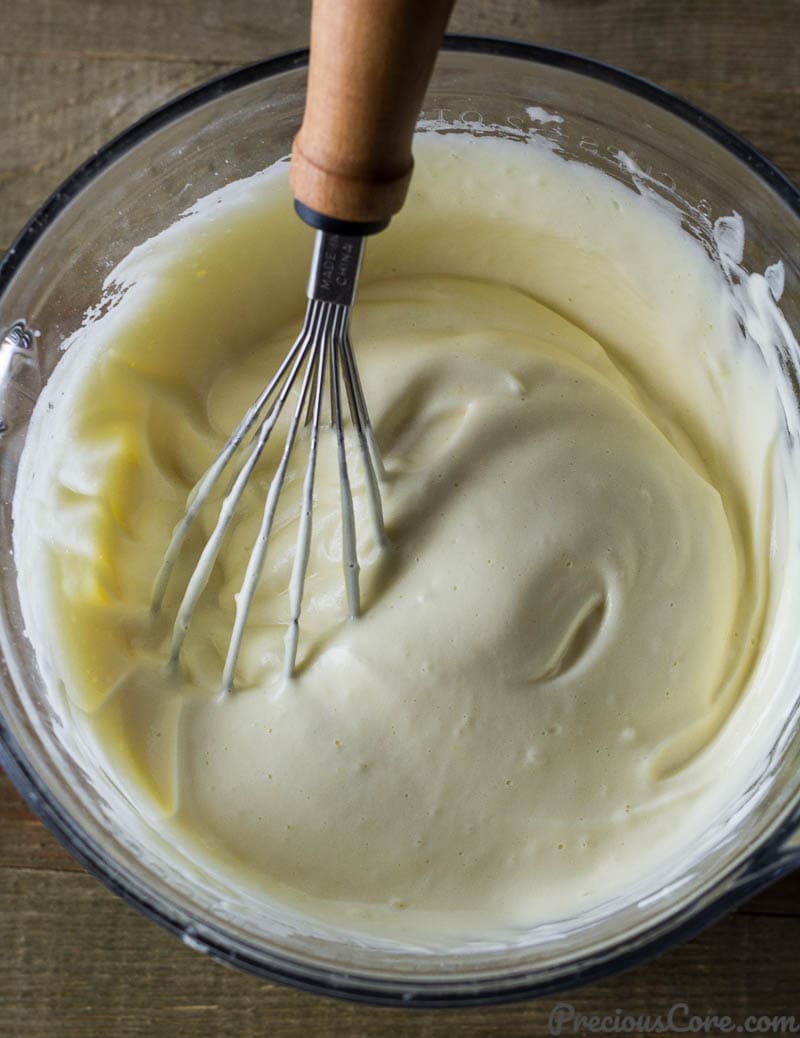 Whisk in a bowl with egg whites, vanilla, and egg yolks.