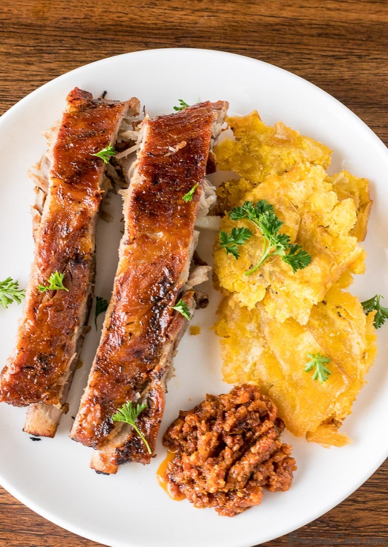 Tostones on a plate with meat.