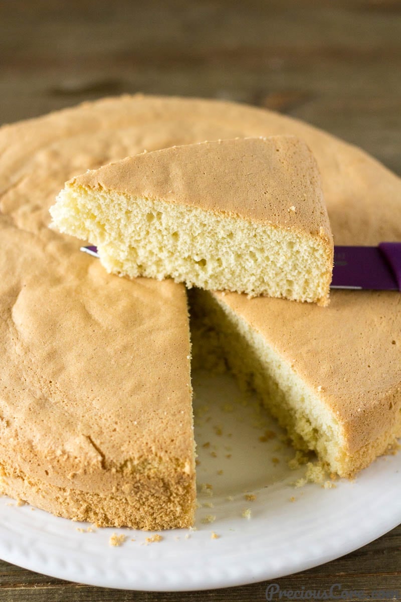 Vanilla Sponge Cake with a slice removed and on a knife.