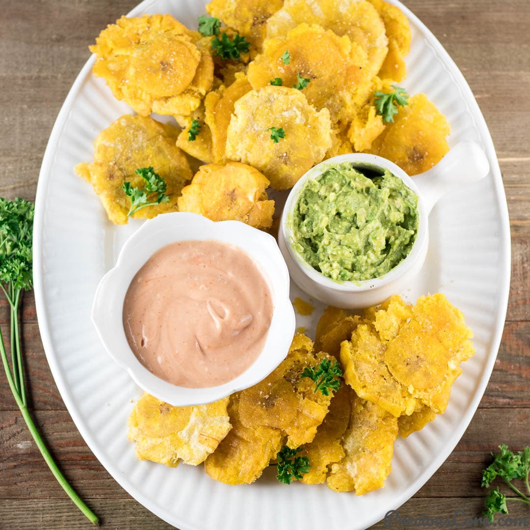 Tostones on a plate with dips.