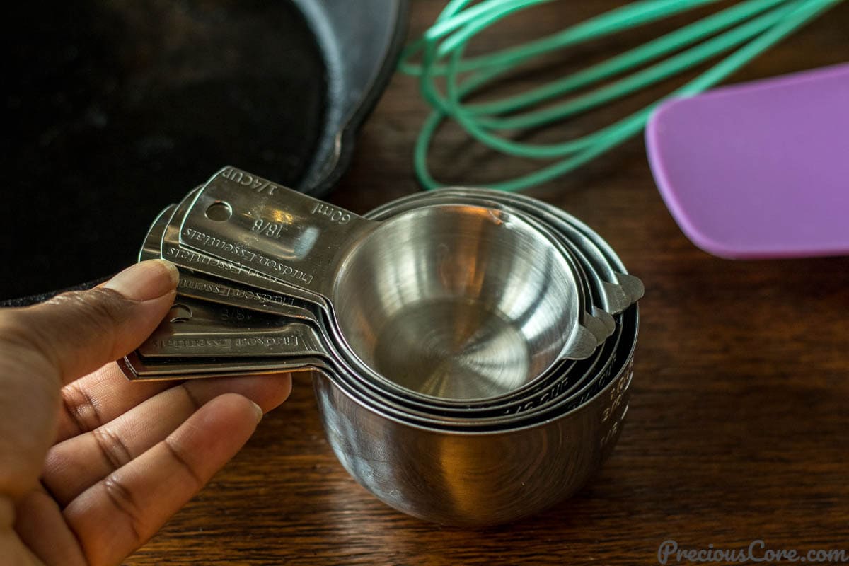 Hand holding measuring cups