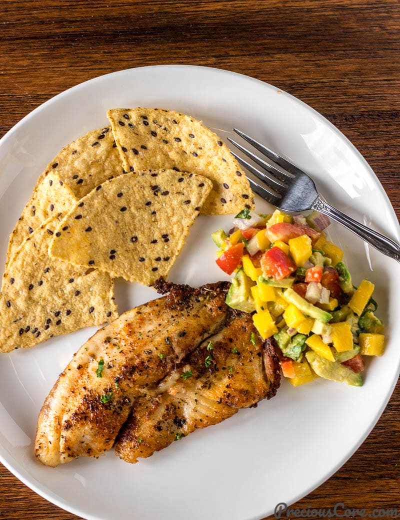 Mango Avocado Salsa served on a plate with grilled fish and tortilla chips