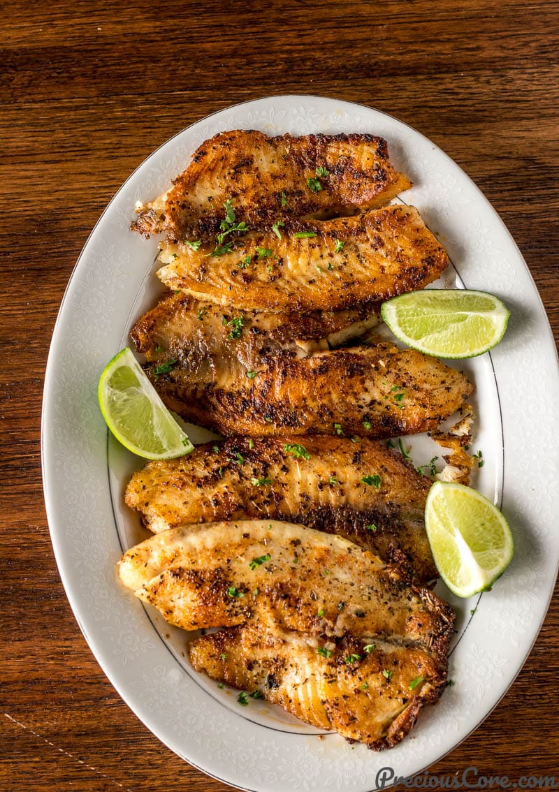 Pan Seared Tilapia on a Serving Tray with lime wedges