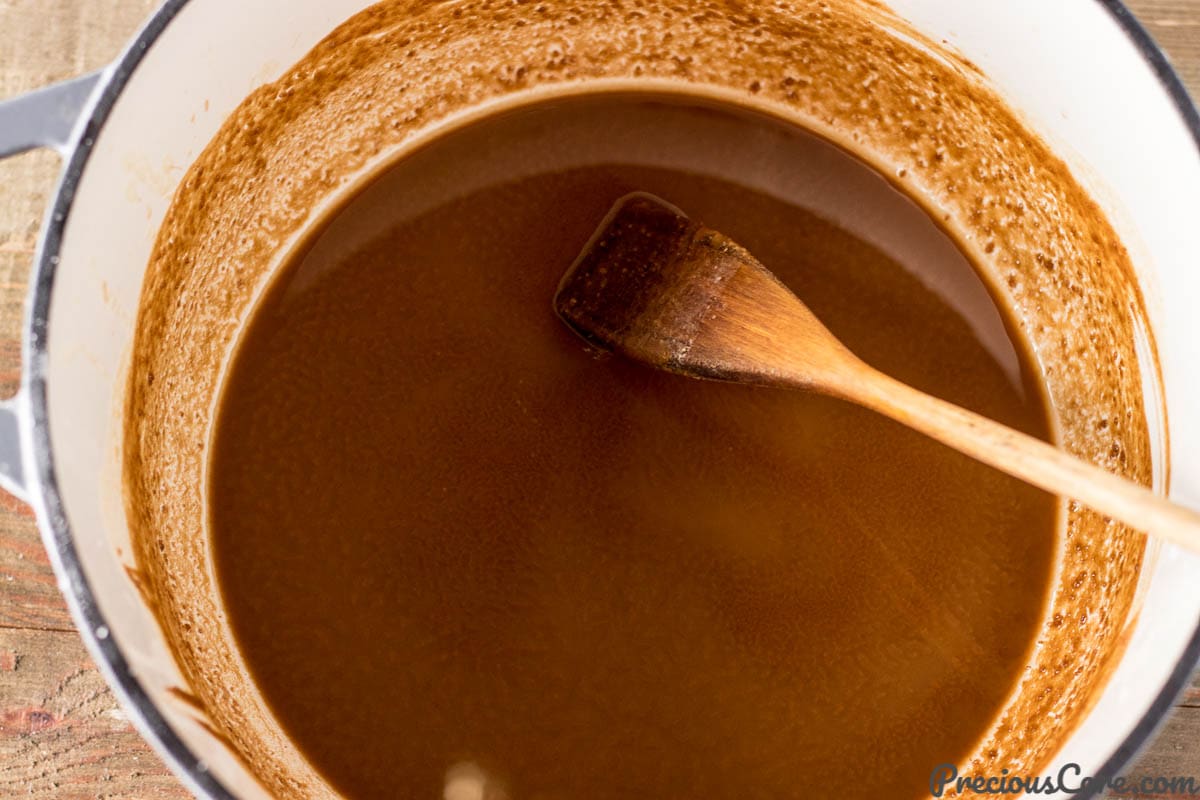 Wooden spoon in a pot of roux.