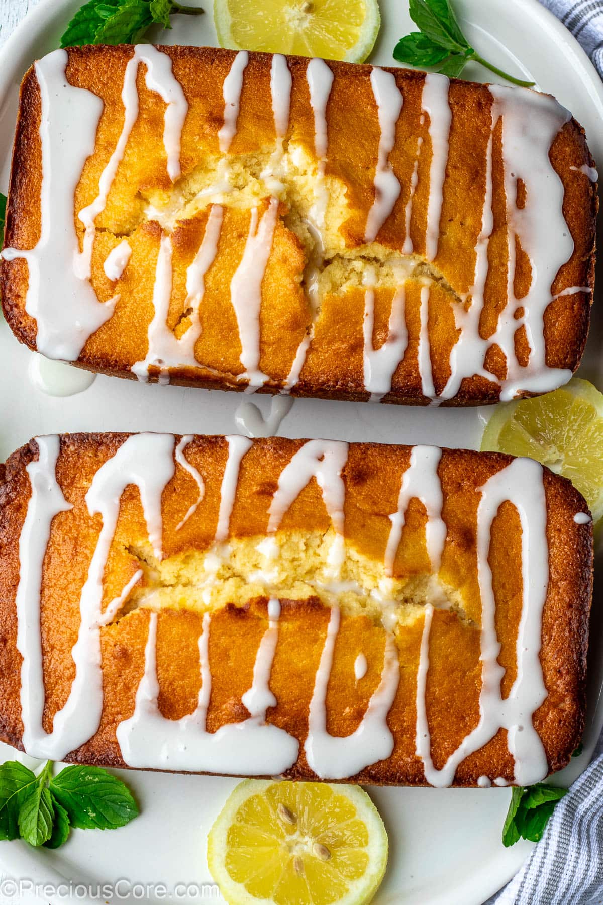 Two loaf cakes with drizzles of lemon glaze on top.