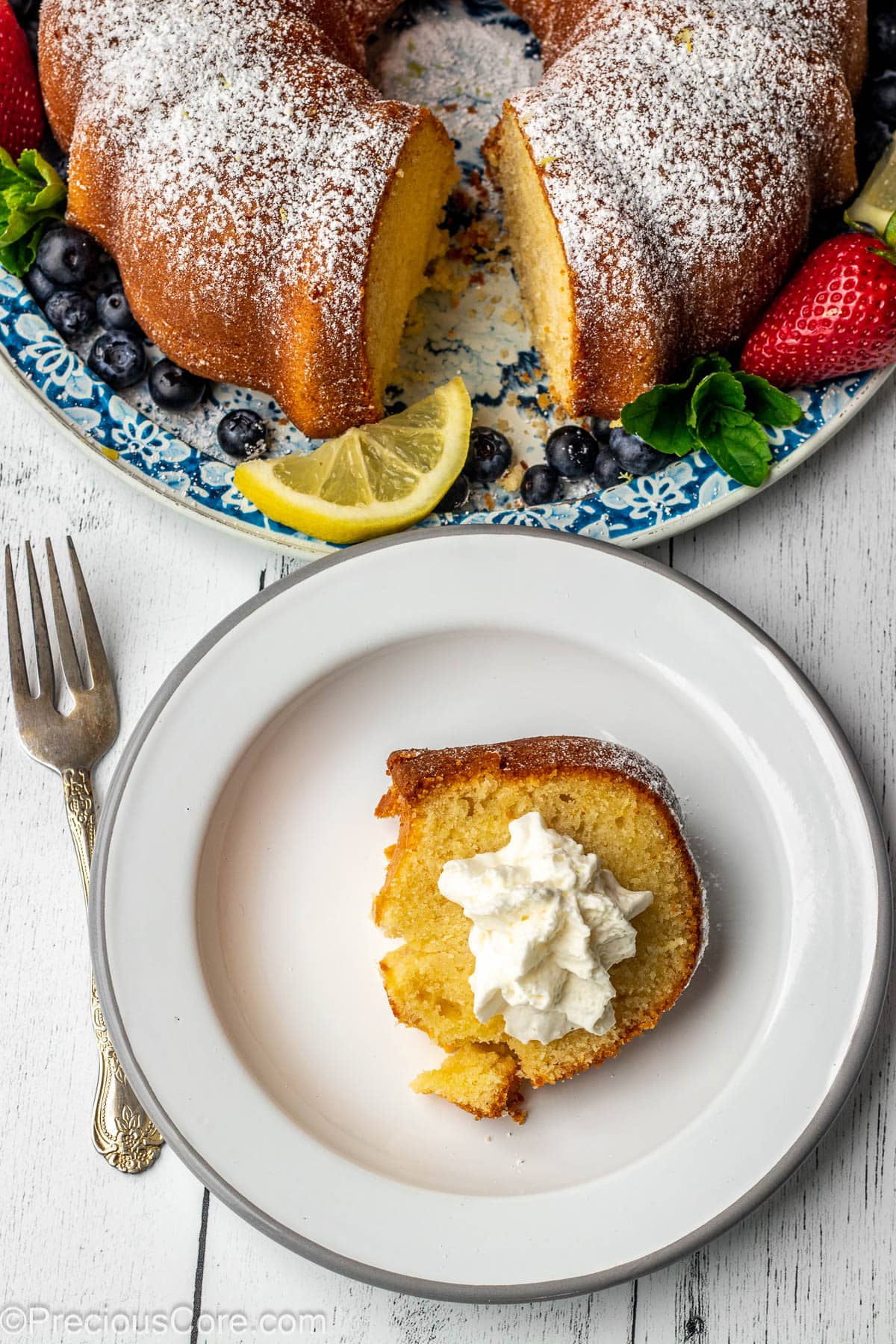 A slice of pound cake topped with whipped cream. 