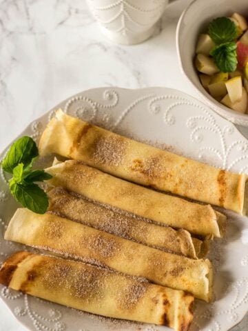 Crepes Served with diced apples and pears in a bowl and coffee