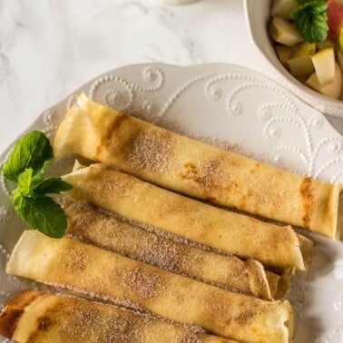 Crepes Served with diced apples and pears in a bowl and coffee