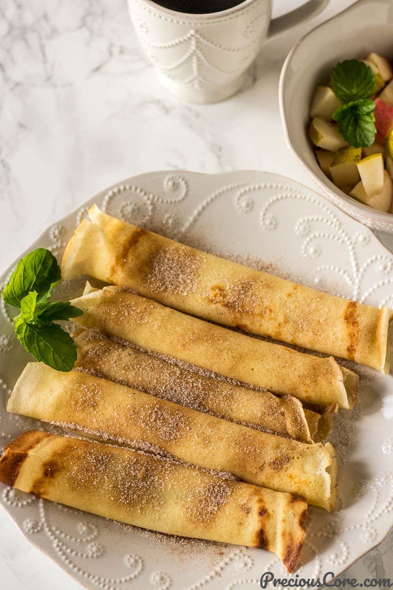 Crepes Served with diced apples and pears in a bowl and coffee