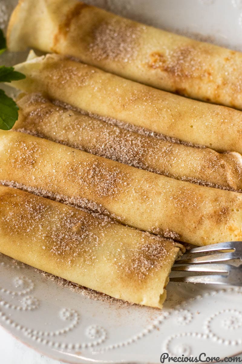 Crepes on a plate sprinkled with cinnamon sugar