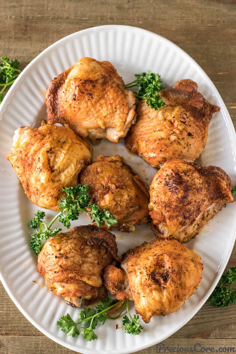 Crispy baked chicken thighs on a serving tray