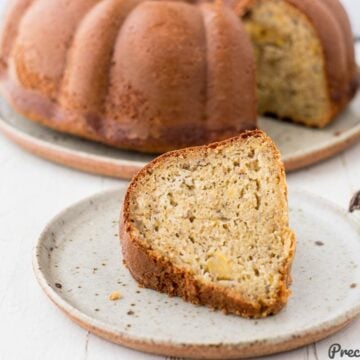 Slice of plantain cake on speckled plate