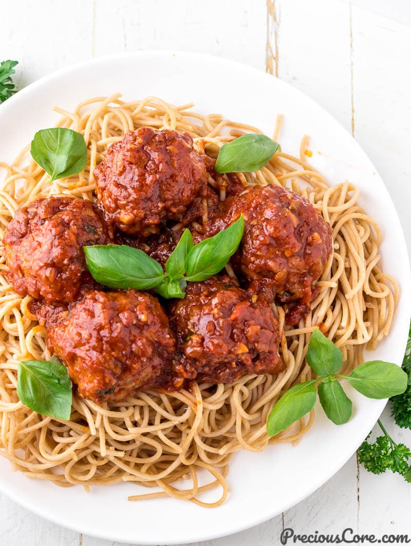 Chicken meatballs served over spaghetti.