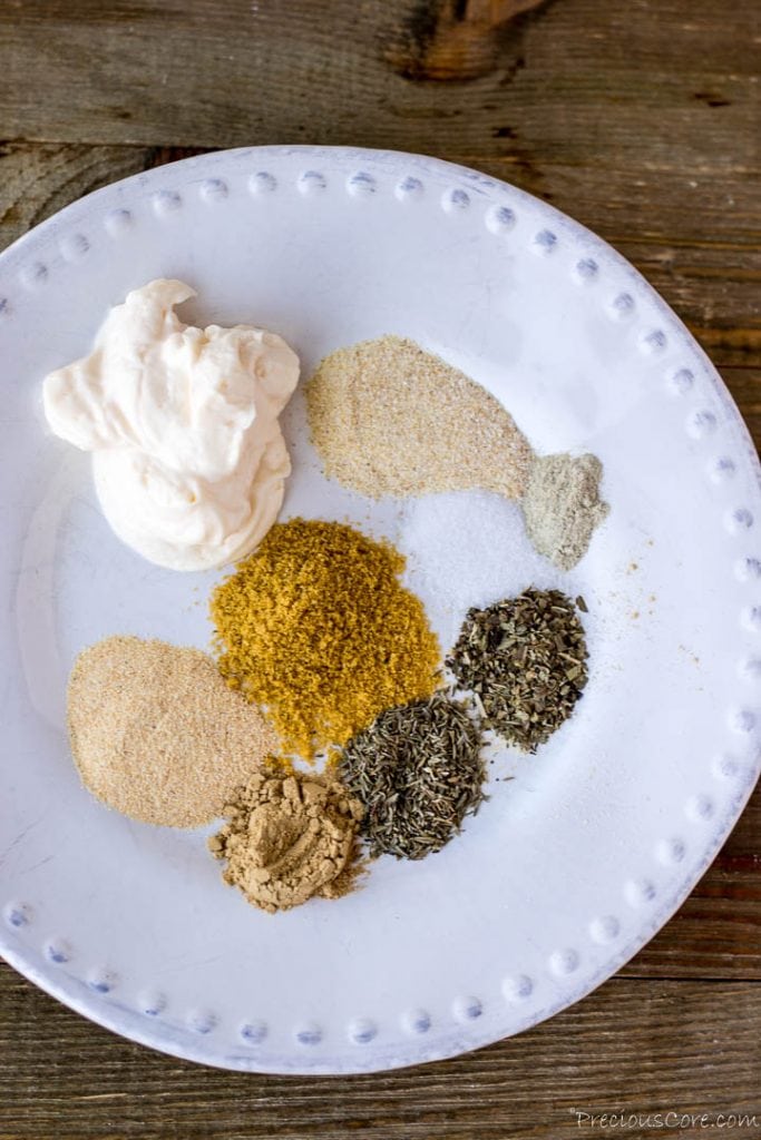 Herbs, dried spices and mayonnaise on a plate