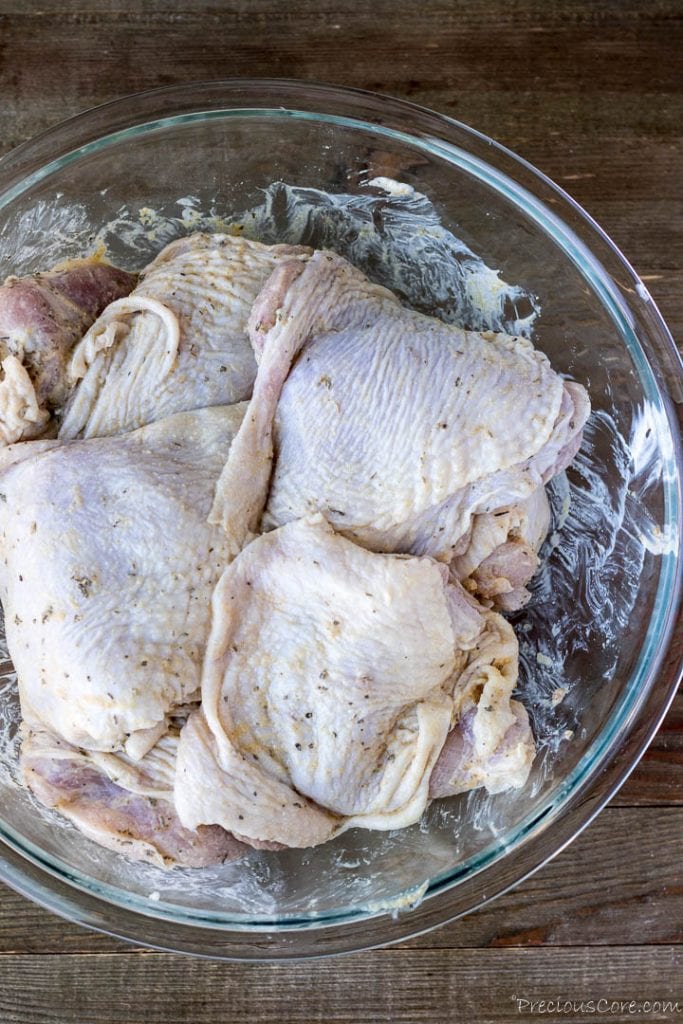 Raw chicken thighs in bowl
