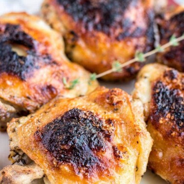 Grilled chicken thighs on a platter