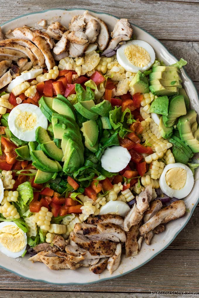 Salad with chicken, eggs, red bell pepper, avocado and romaine lettuce