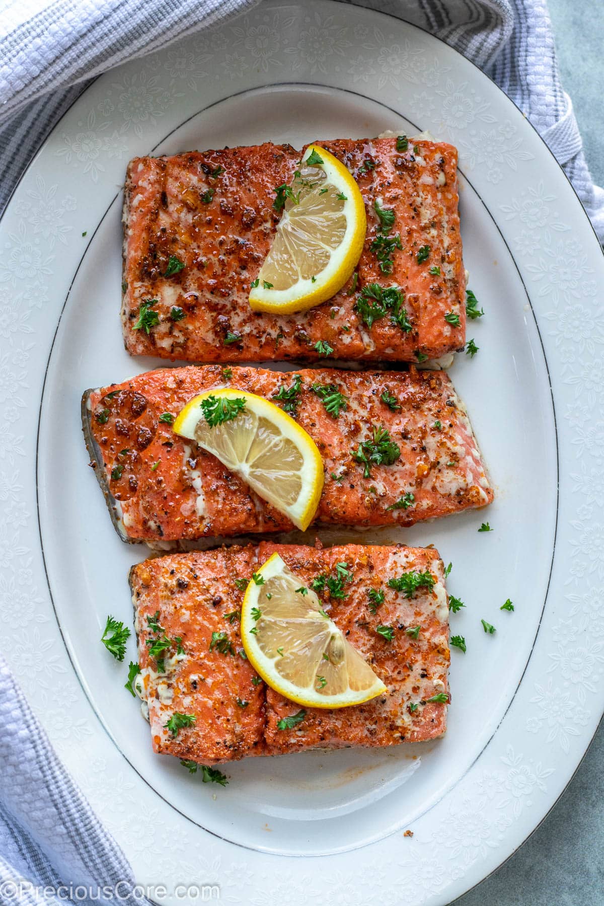 Baked Cajun Salmon on a white serving platter.