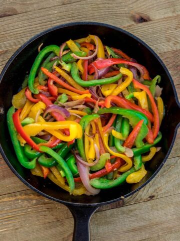 Sauteed peppers and onions in a skillet