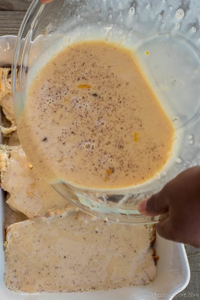 Pouring egg mixture over bread for bread pudding