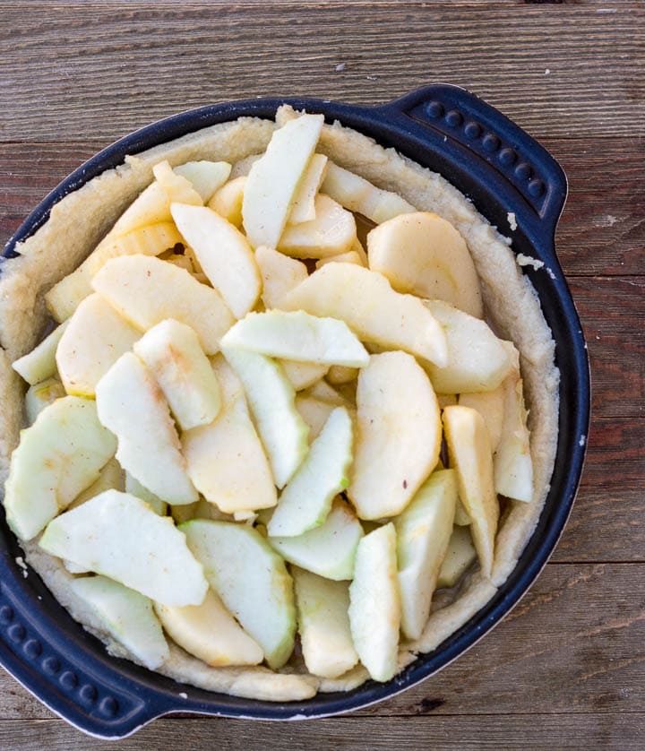 apple pie uncooked filling in baked crust