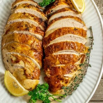 2 sliced baked turkey breasts on serving platter