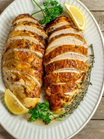 2 sliced baked turkey breasts on serving platter