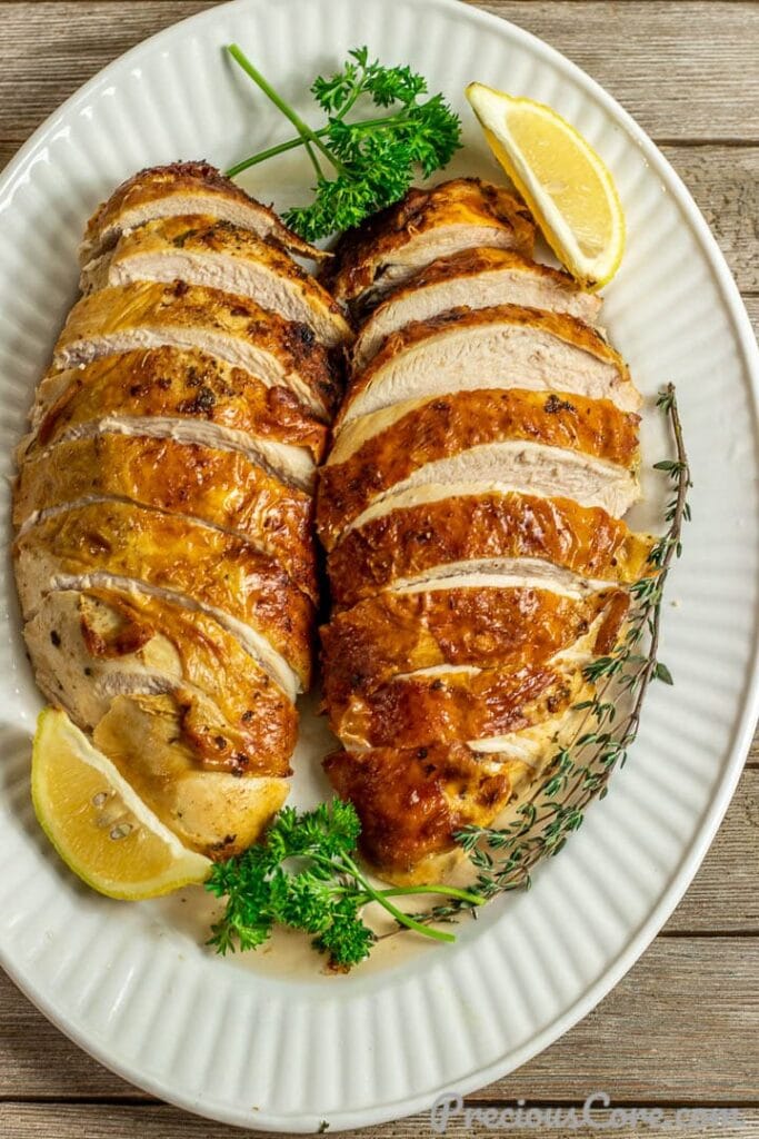 2 sliced baked turkey breasts on serving platter