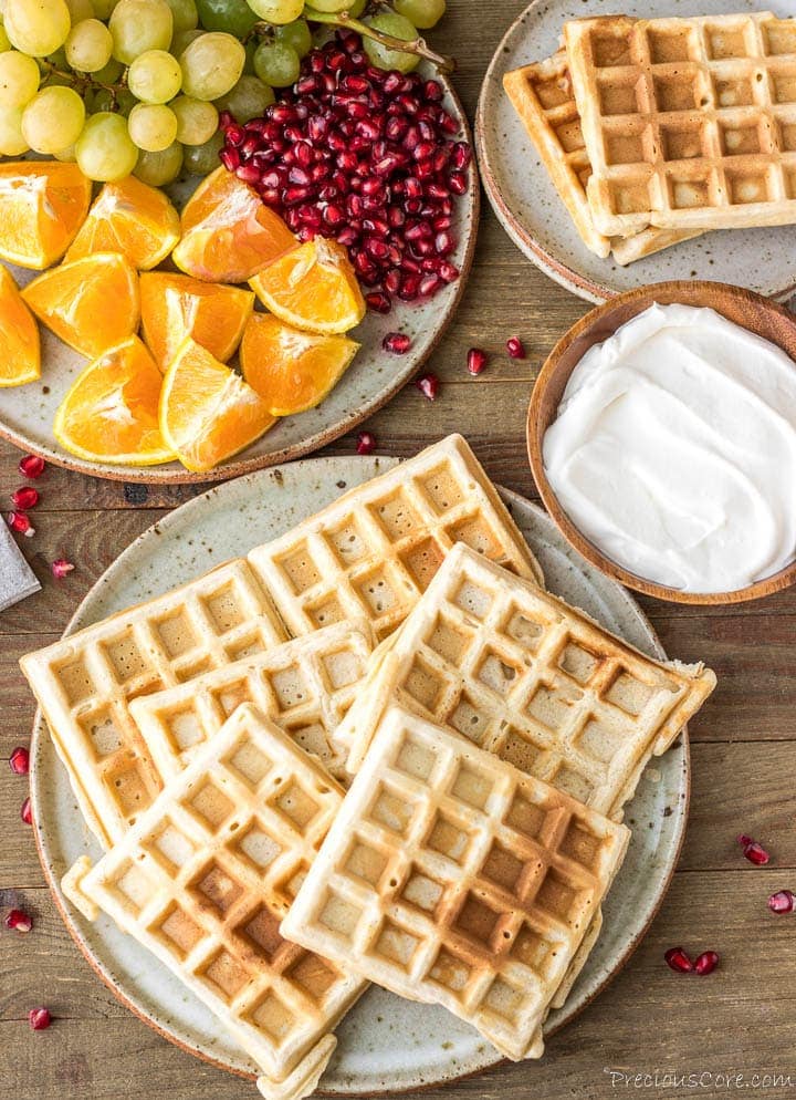 Homemade Waffles on a plate with whipped cream on the side