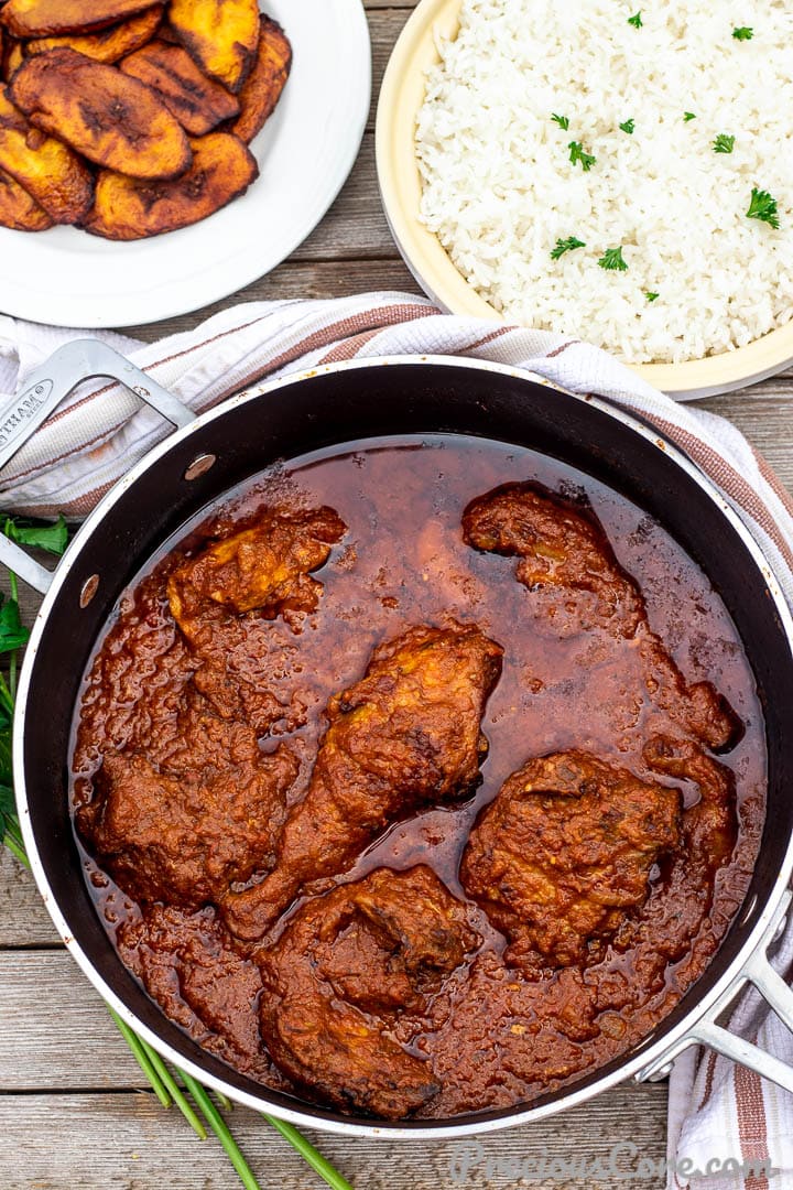 Bowls of African tomato stew, rice and plantains